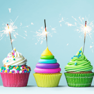 Three Colorful Cupcakes with sparklers for celebrating