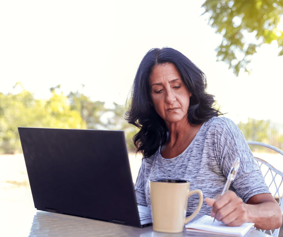 Woman studying online and taking notes